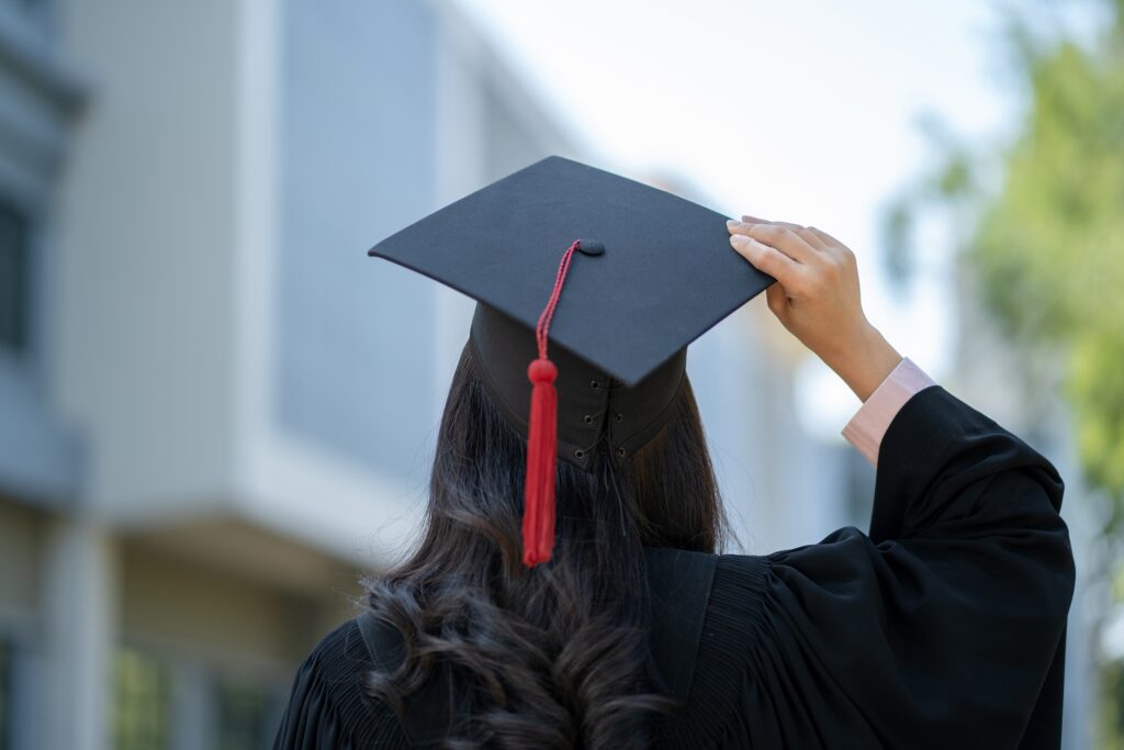 A woman graduating and joining the largest alumni network in the world.